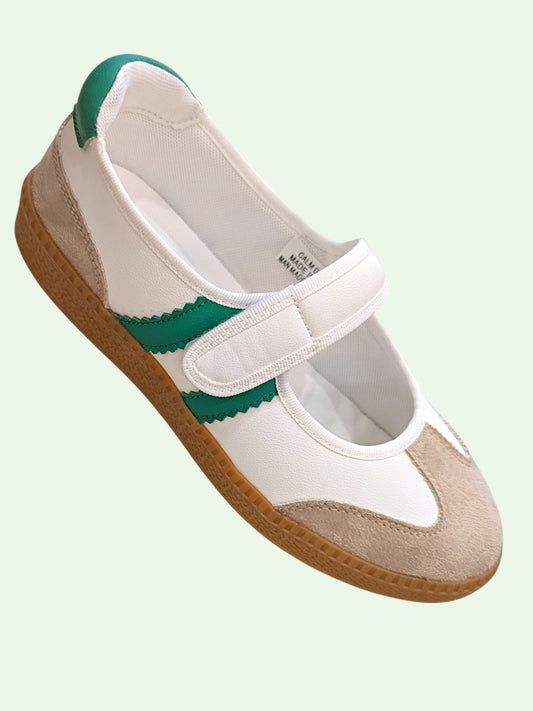White shoe with green accents on a light green background