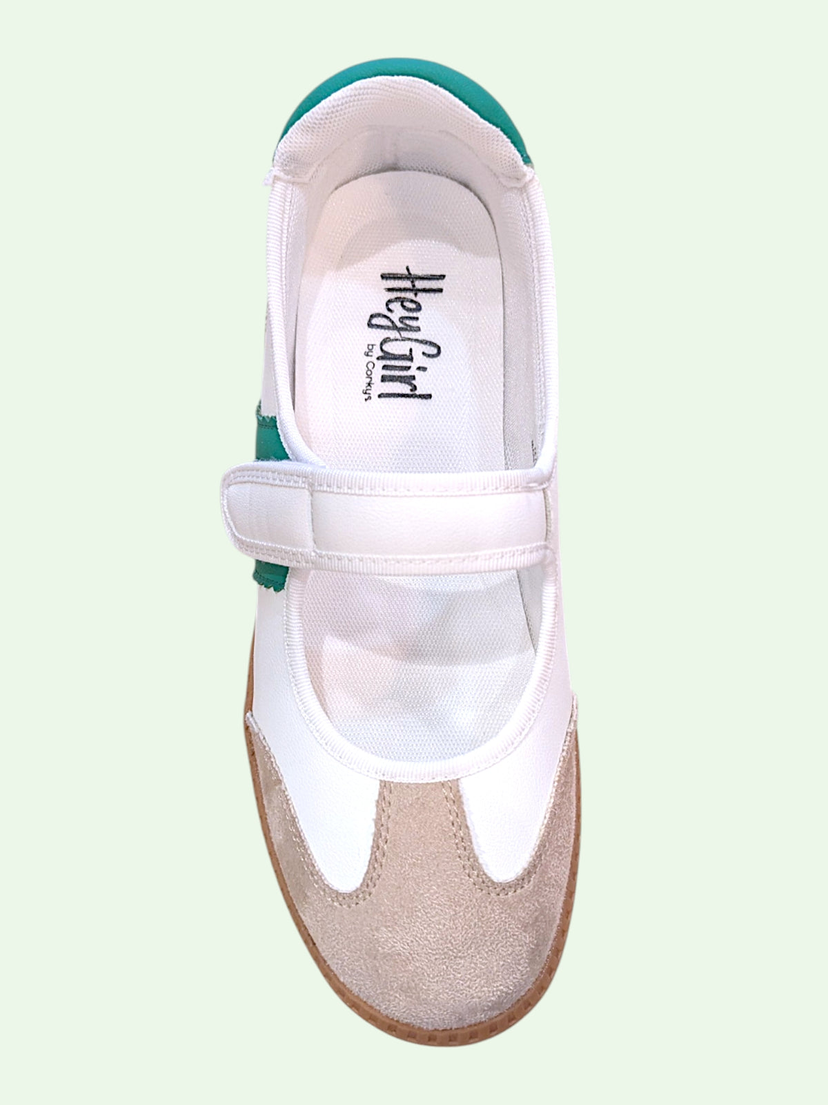 White shoe on a light green background