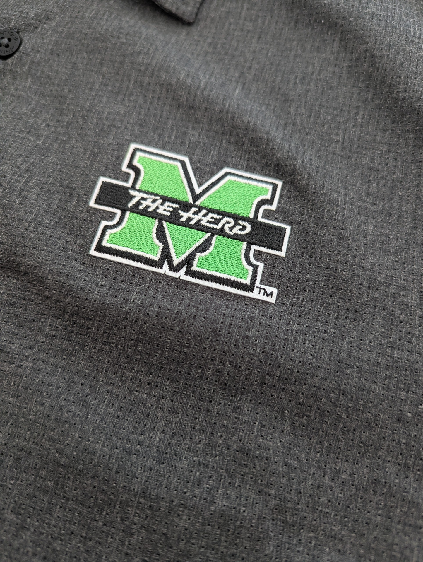 Gray polo shirt with a green and white logo on the chest