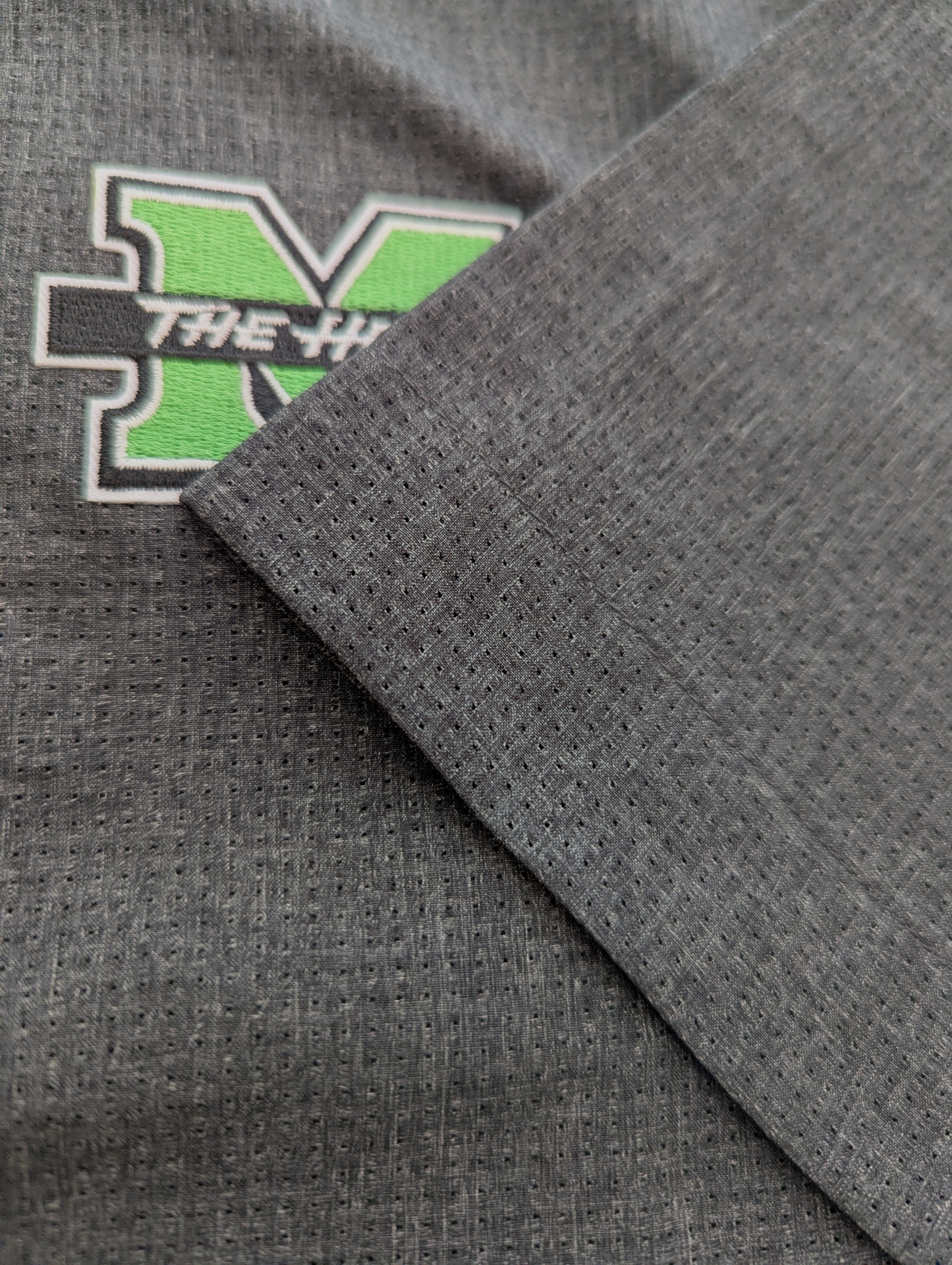 Gray fabric with a green and white logo on a gray background