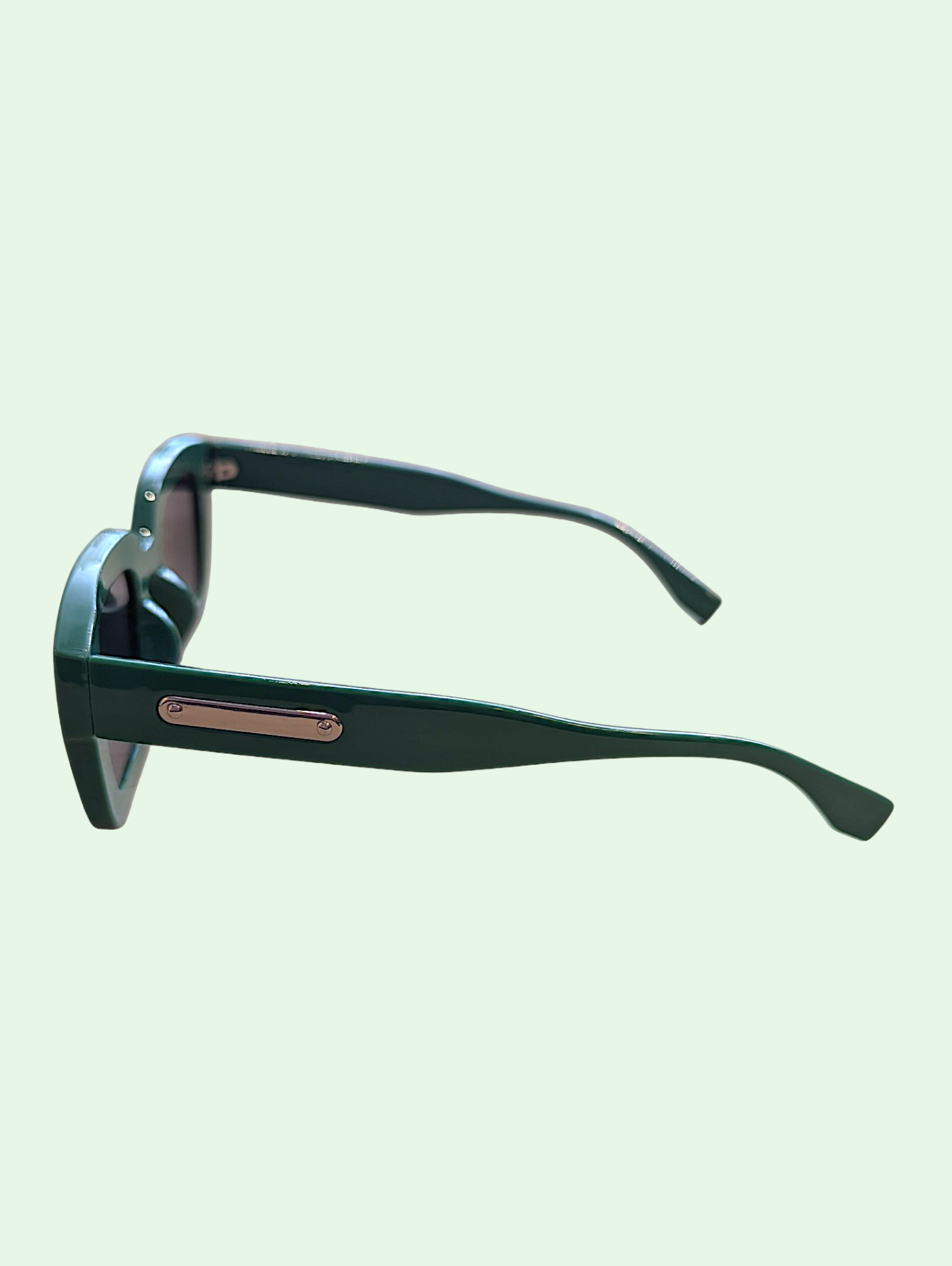 Sunglasses with black frame and rose gold accents on a light green background