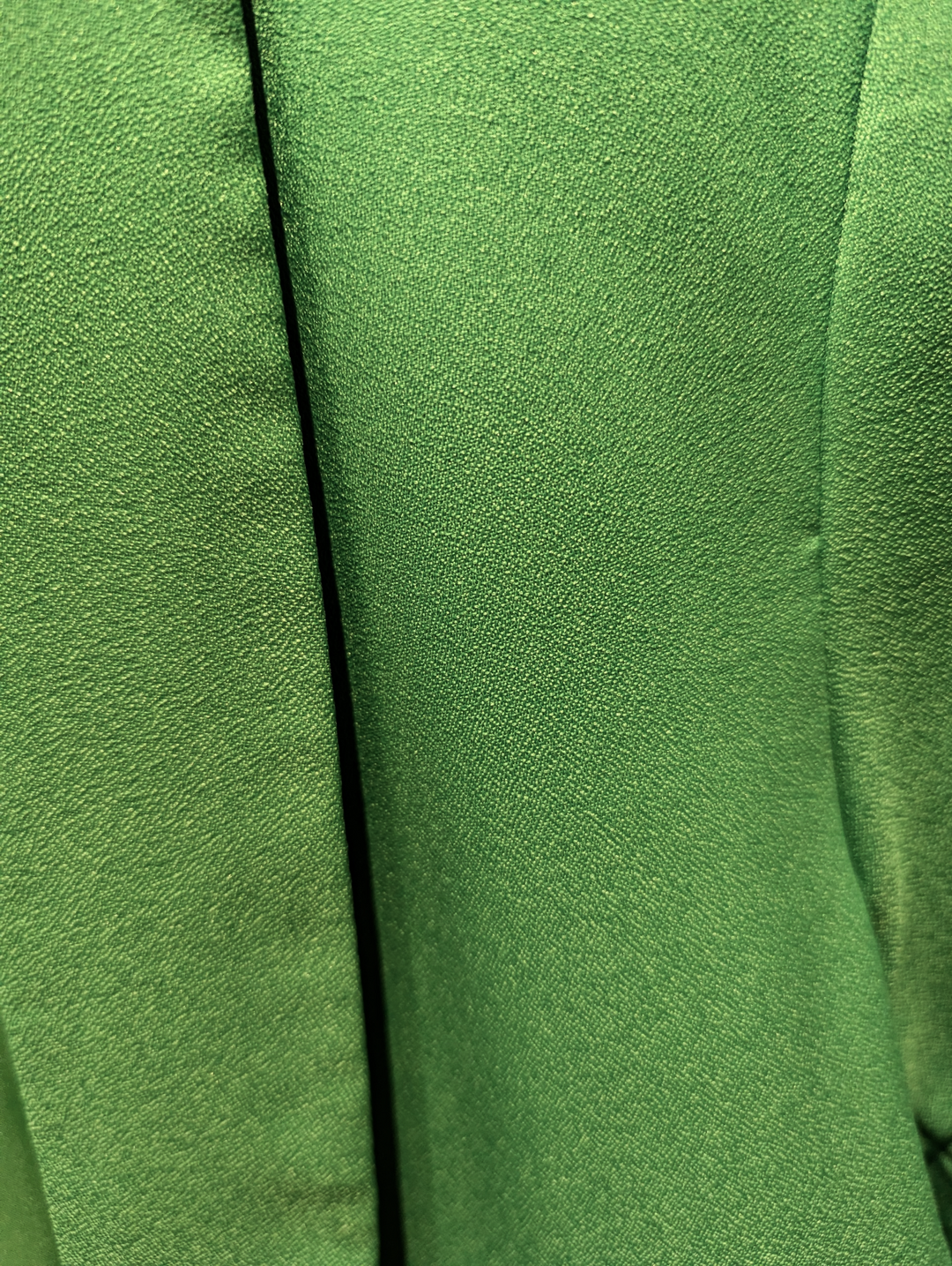 Close-up of green fabric with a seam