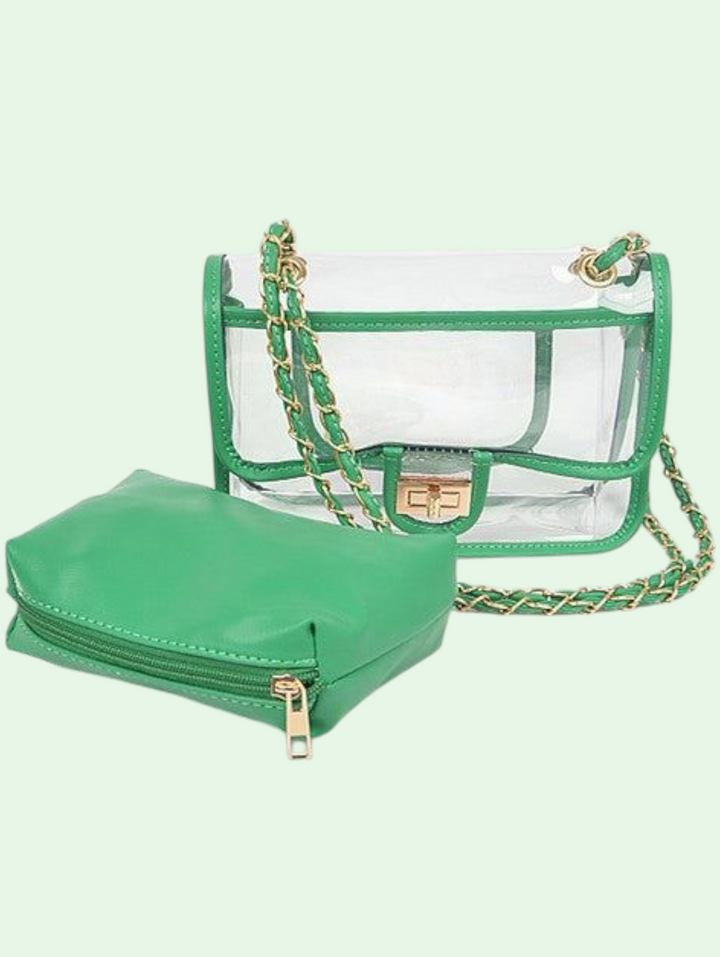 Green handbag with a clear pouch and gold chain on a light green background