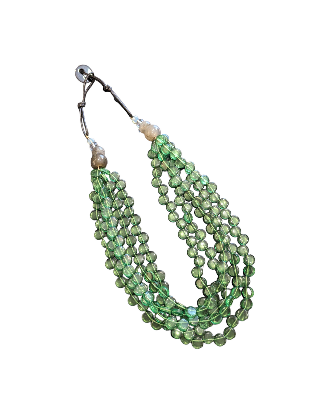 shades of green beads in several strands fall from a central clasp
