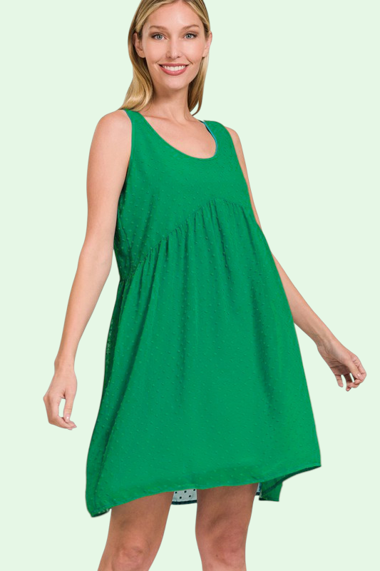 Woman wearing a green sleeveless dress on a light green background