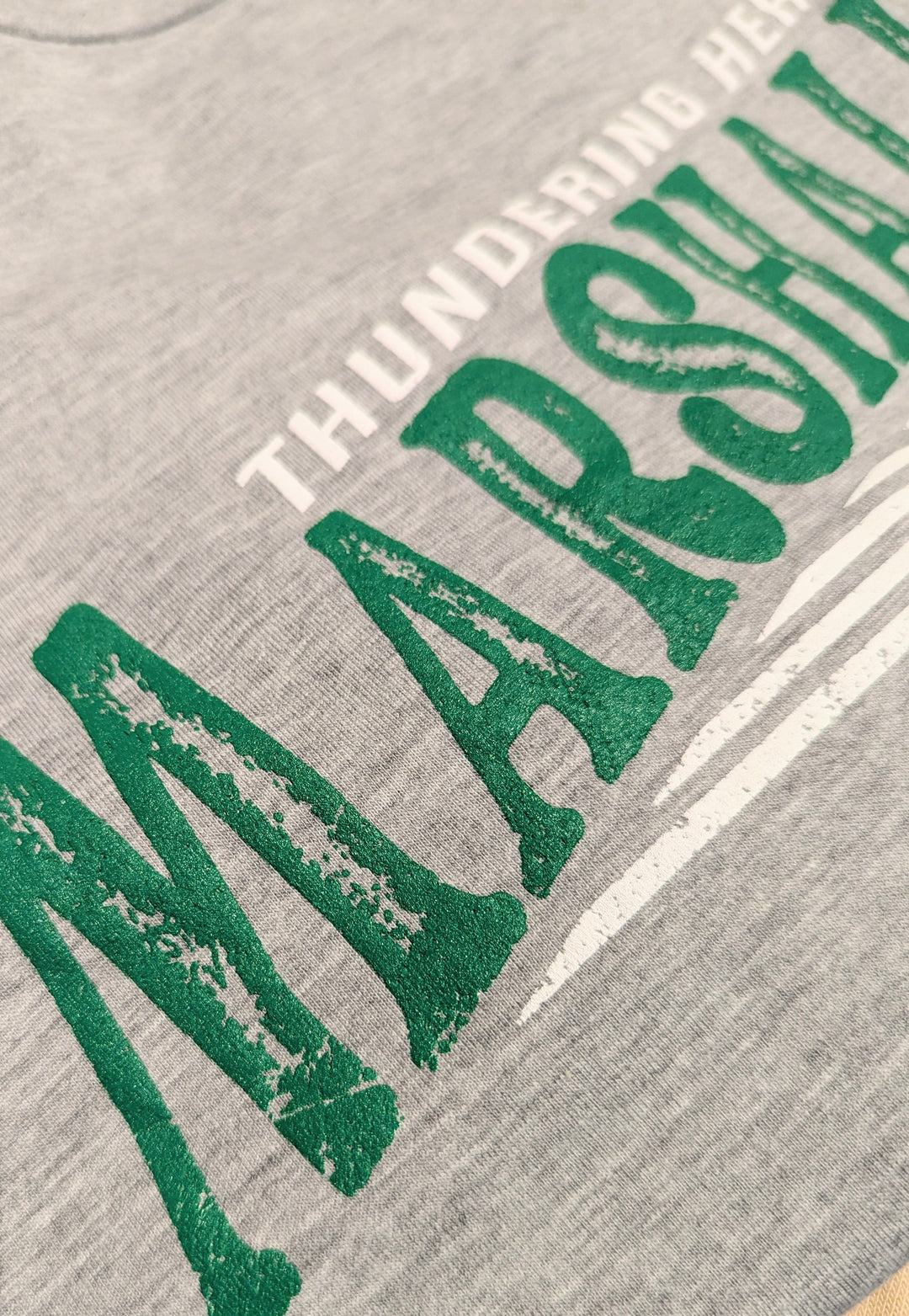 A close up of the distress detail on the marlett tee