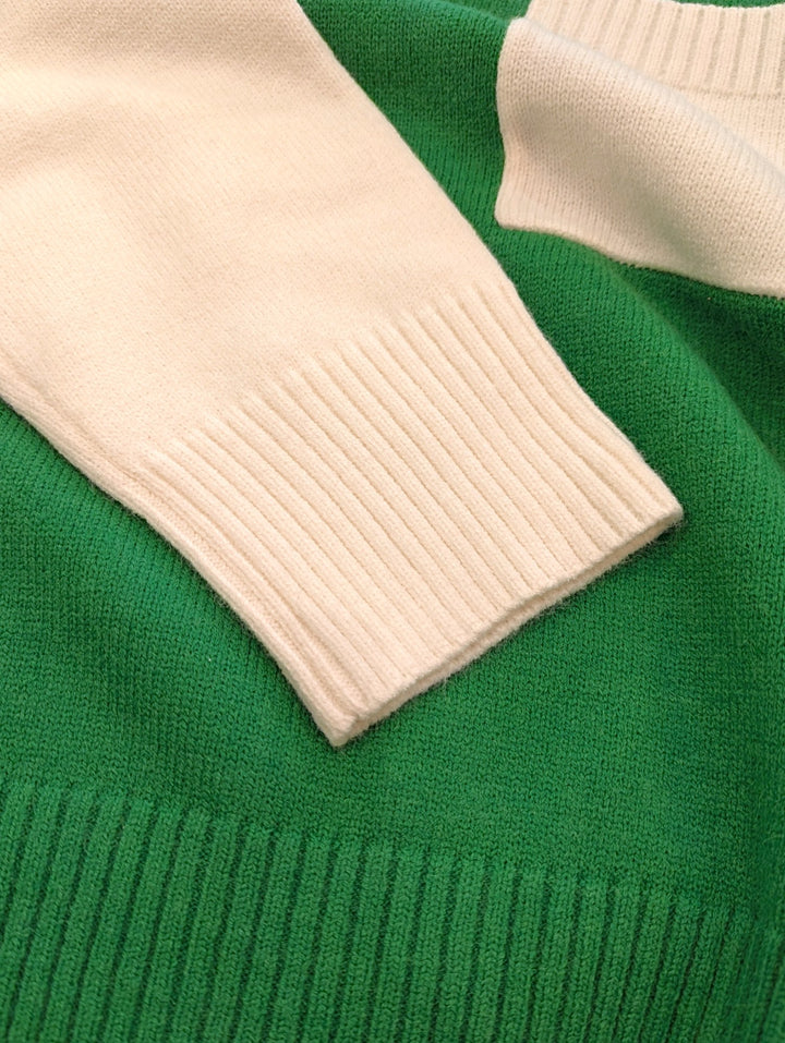 Close-up of a green sweater with white cuffs