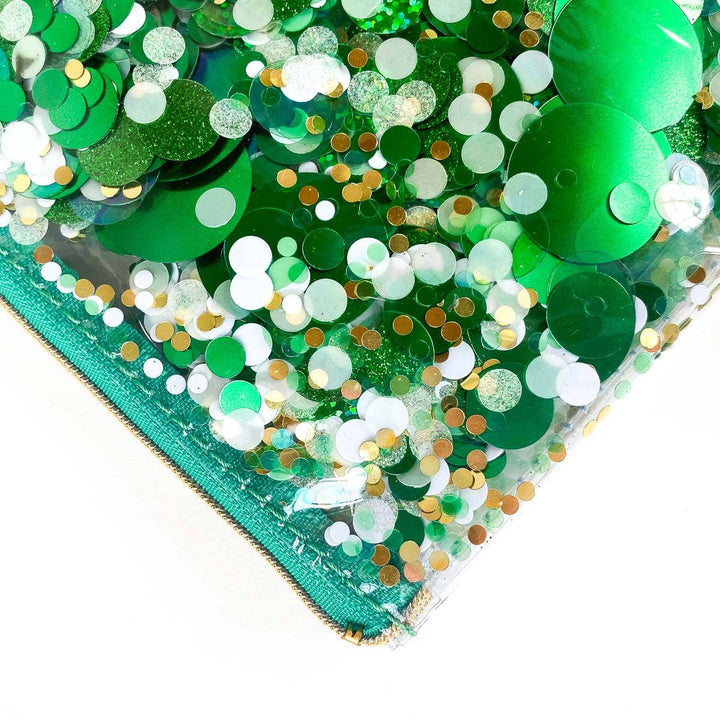 Close-up of green sequins and glitter on a white background