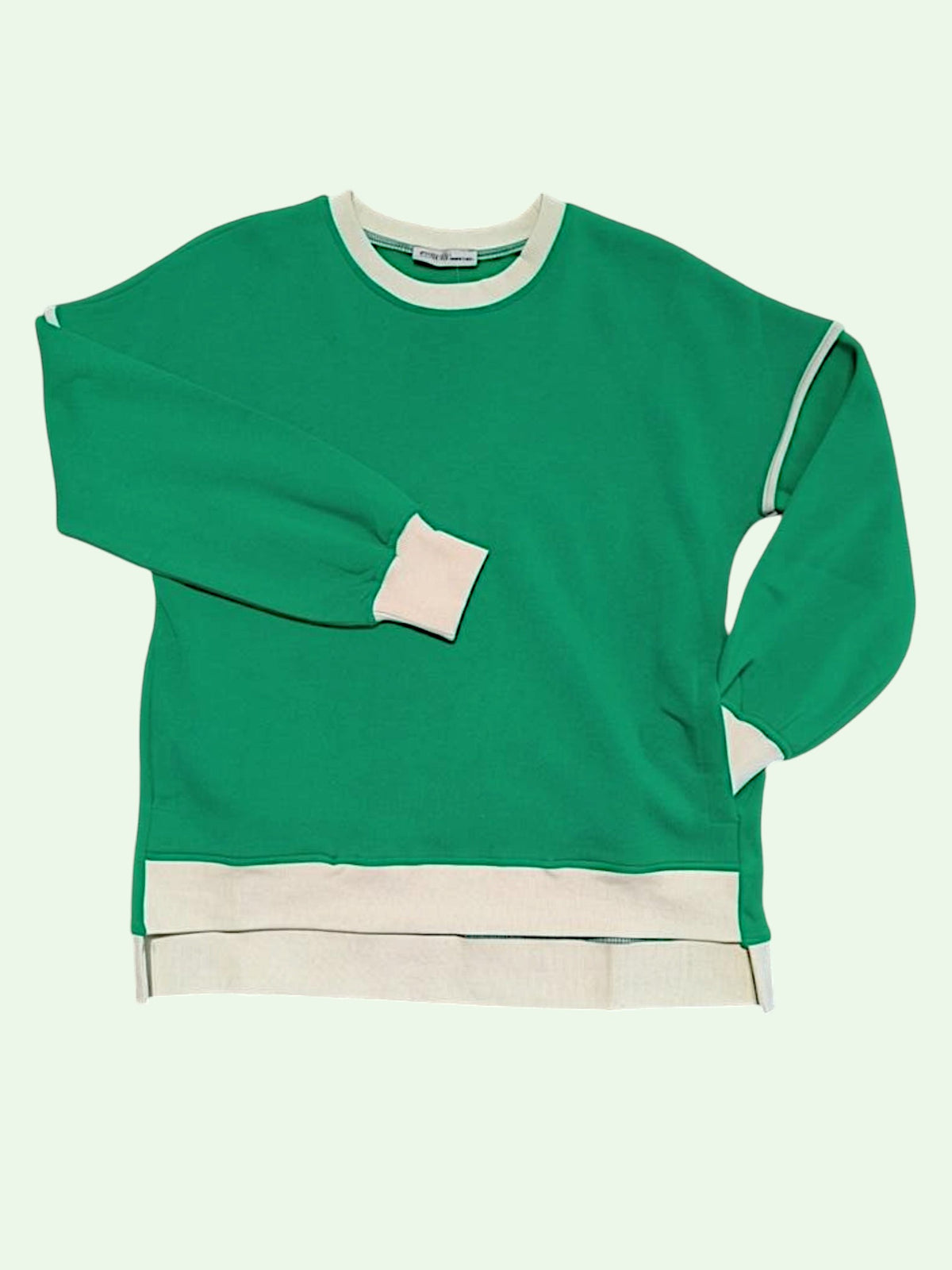 A green crewneck sweatshirt with contrasting cream ribbed trim at the collar, cuffs, hem, and side seams, displayed flat against a pale mint green background.