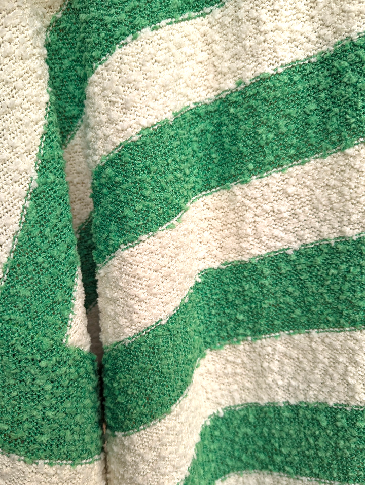 Close-up of a green and white striped patterned cardigan