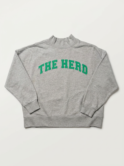 A heather gray mock neck sweatshirt with 'THE HERD' printed in green arched block letters across the chest, displayed flat against a light off-white background.