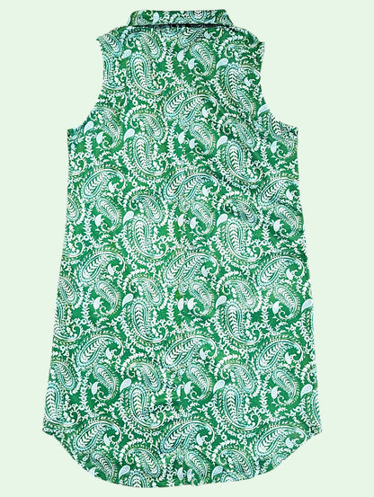 A sleeveless collared shirt dress featuring an all-over green and white paisley pattern, shown against a solid pale green background.