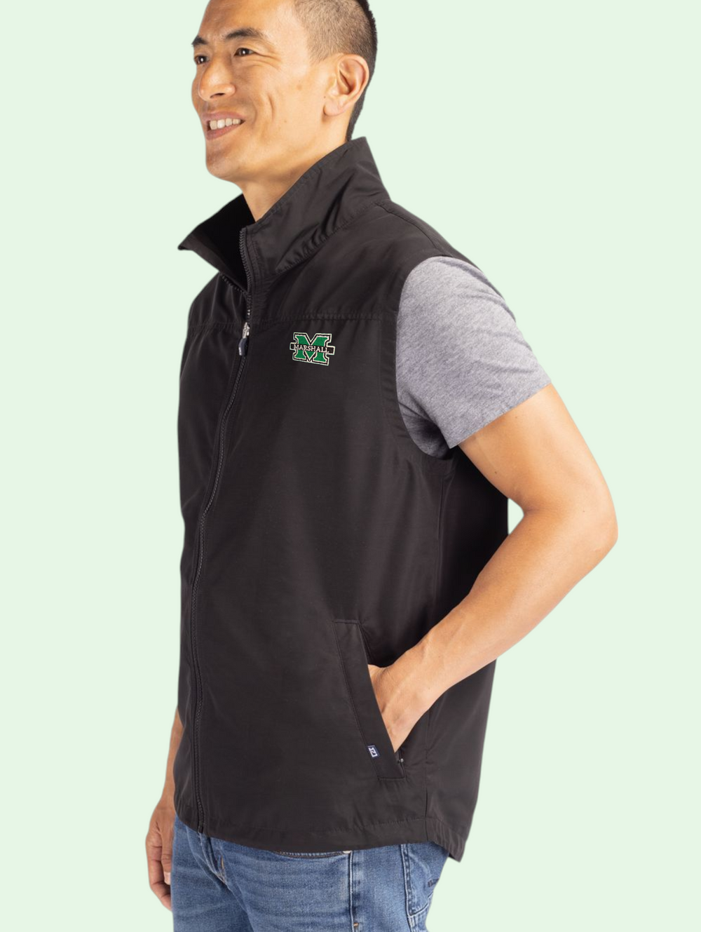 a model with close cropped dark hair shows us the vest. he stands at a three quarter view with his hand on one pocket