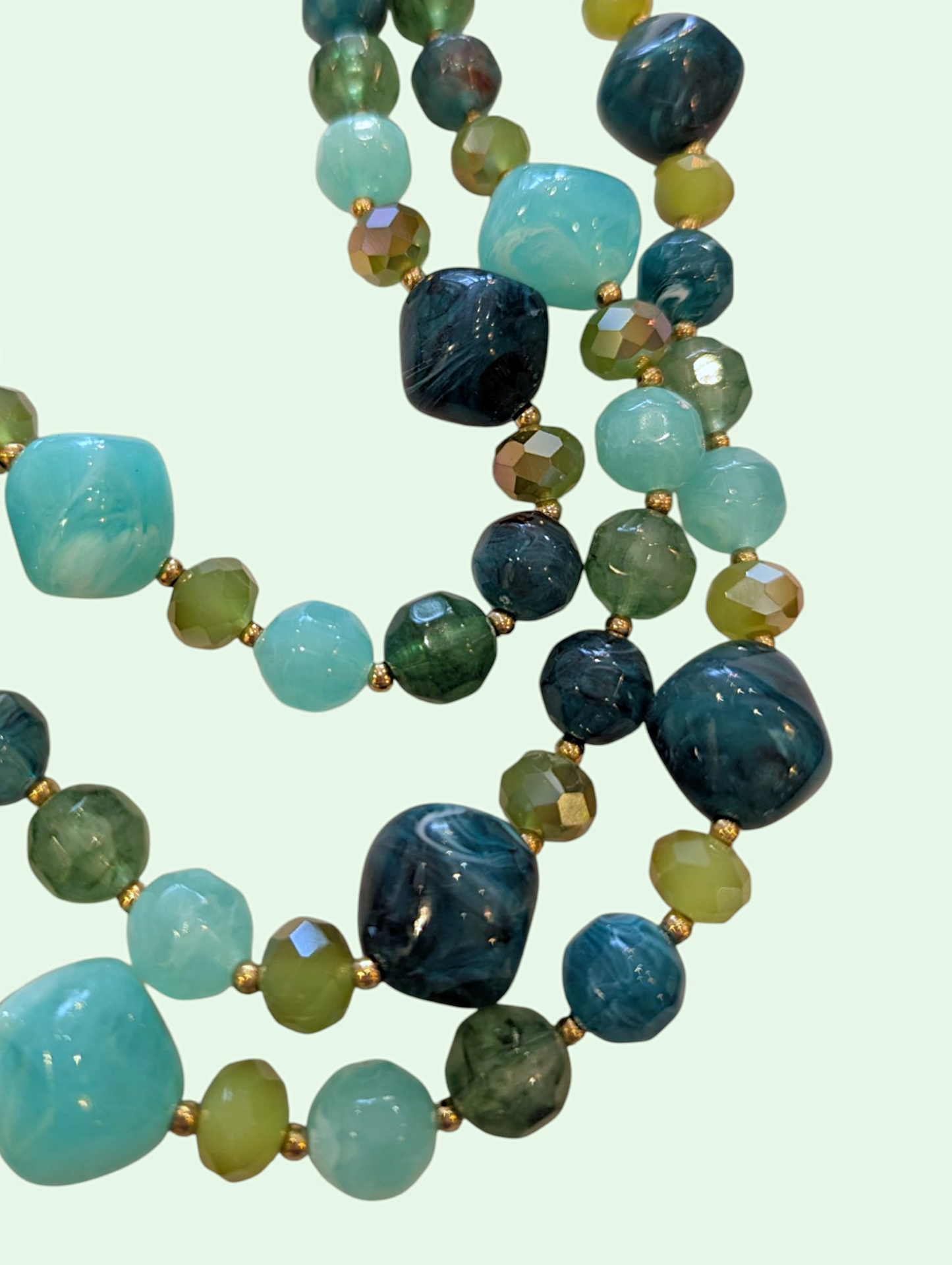 a detail shot of the green and blue beads on the erica necklace