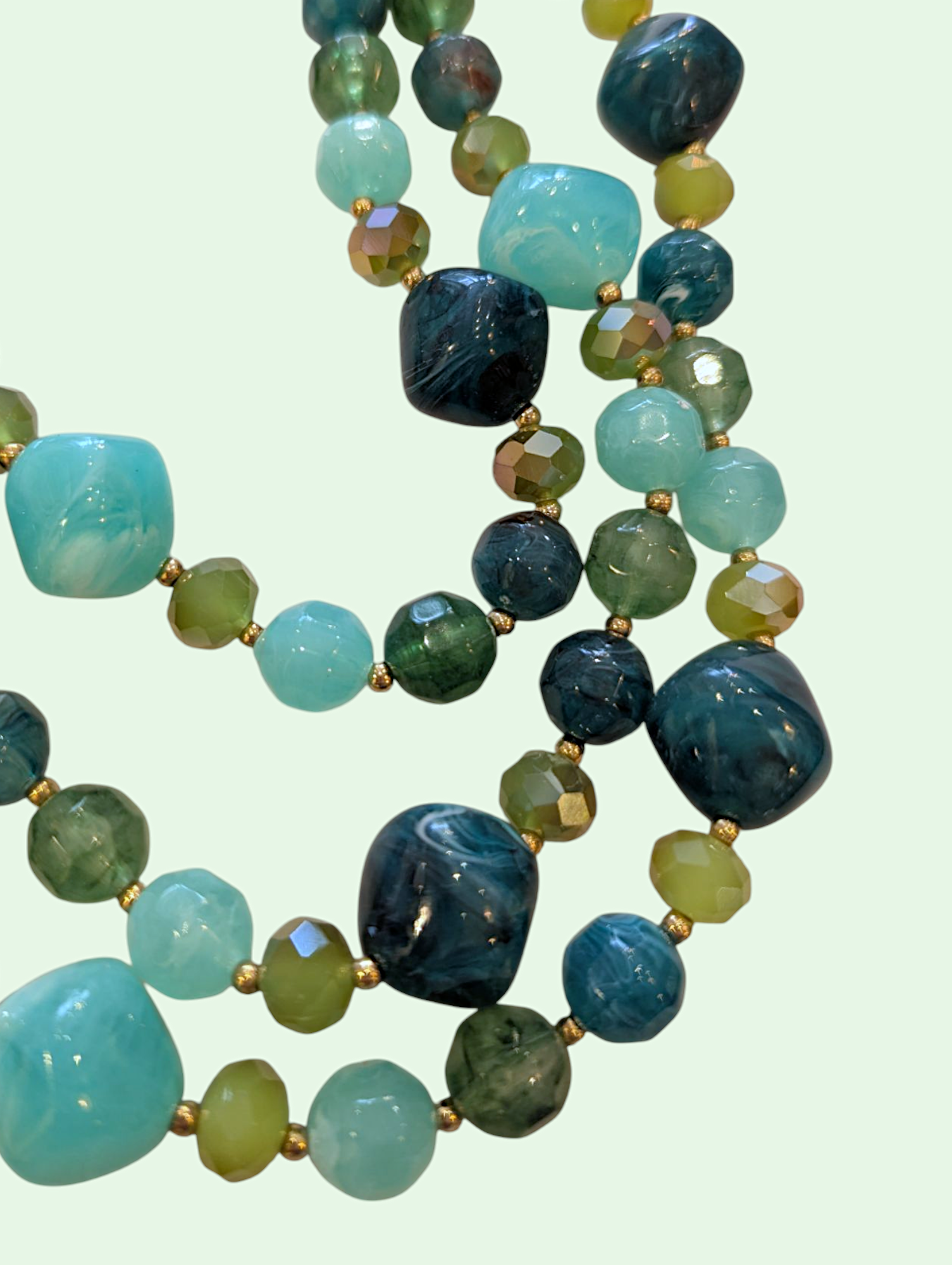 a detail shot of the green and blue beads on the erica necklace