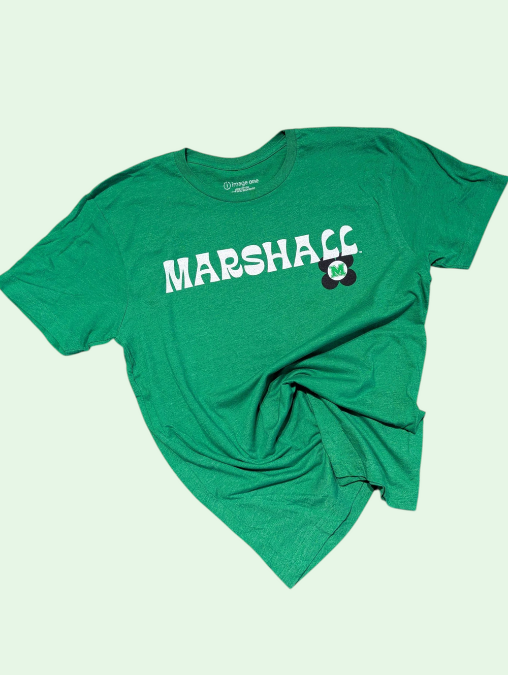 Green t-shirt with 'MARSHALL' printed on it against a light green background