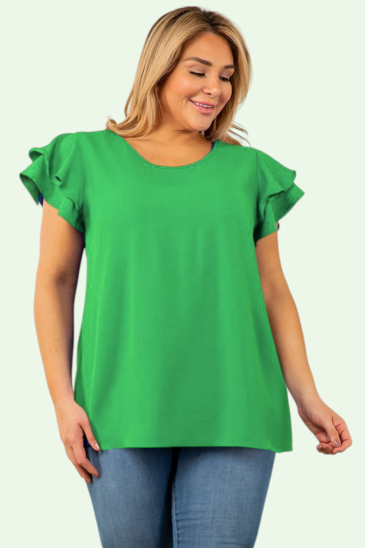Woman wearing a green blouse with ruffled sleeves on a light green background