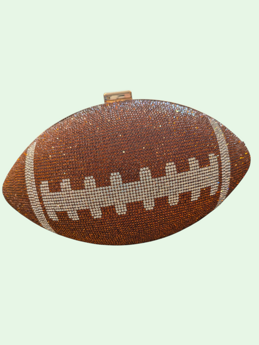 Football-shaped clutch bag with rhinestone details on a light green background