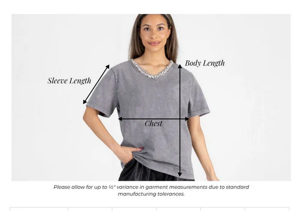 Woman wearing a gray t-shirt with measurement labels on a white background