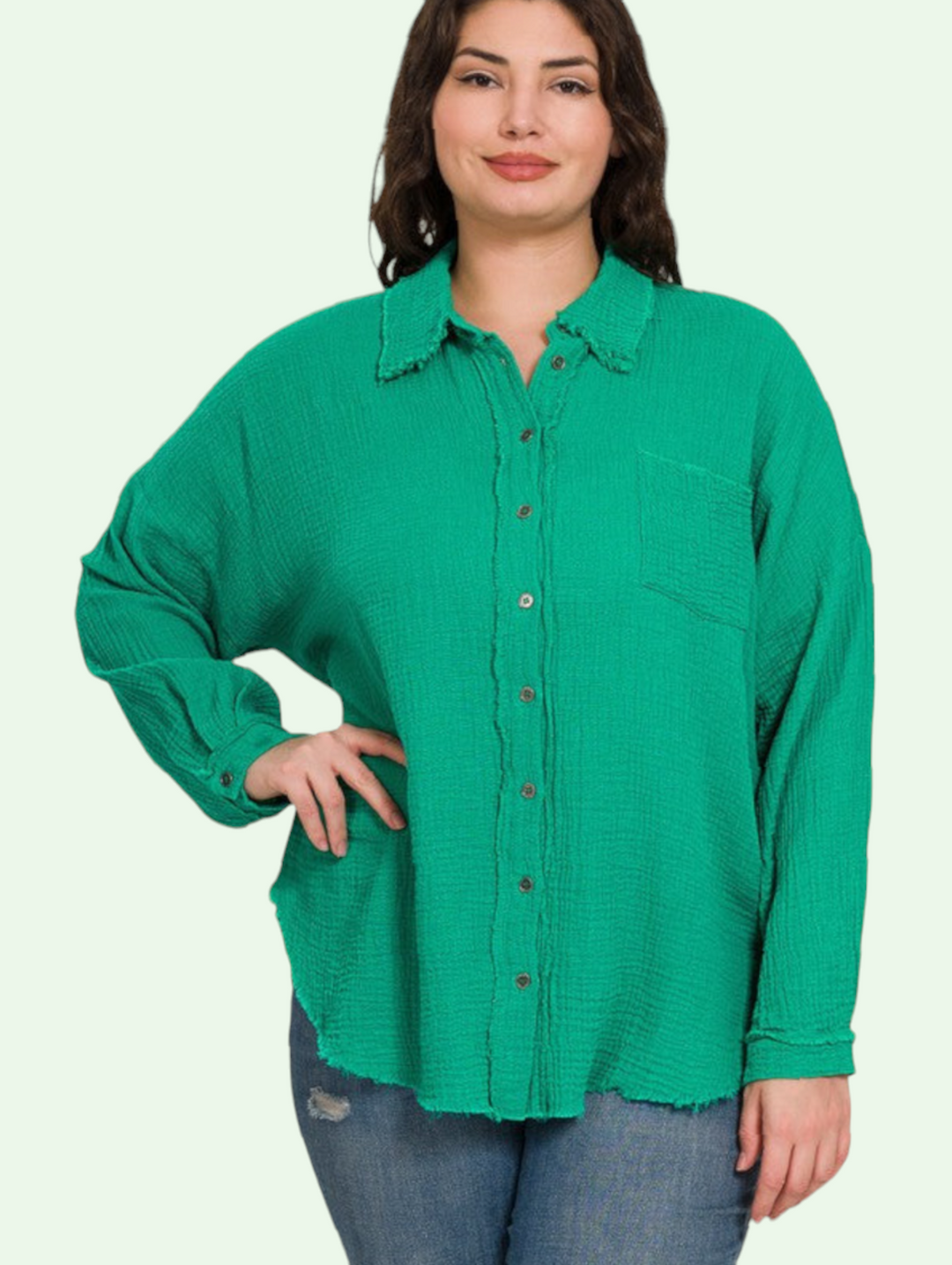 a dark haired plus sized model stands,  hand on hips and shows us the buttoned up version of the gauze shirt