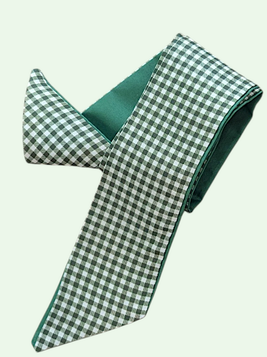 Green and white checkered tie on a light beige background