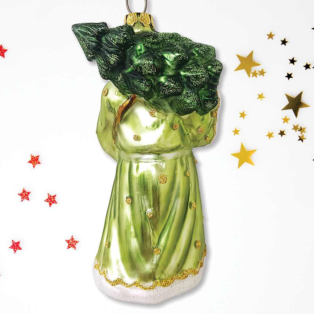 Decorative green angel ornament with gold accents on a white background with decorative stars.