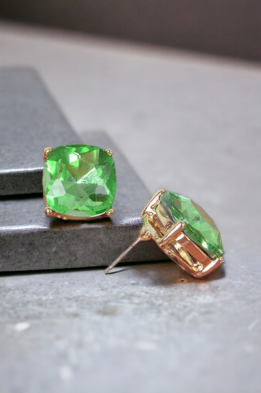 the green stud earrings like on a multi-level metallic surface