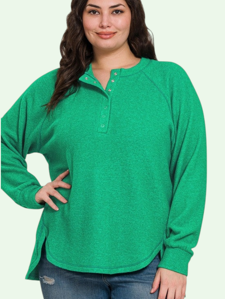 a dark haired model shows us the green henley sweater