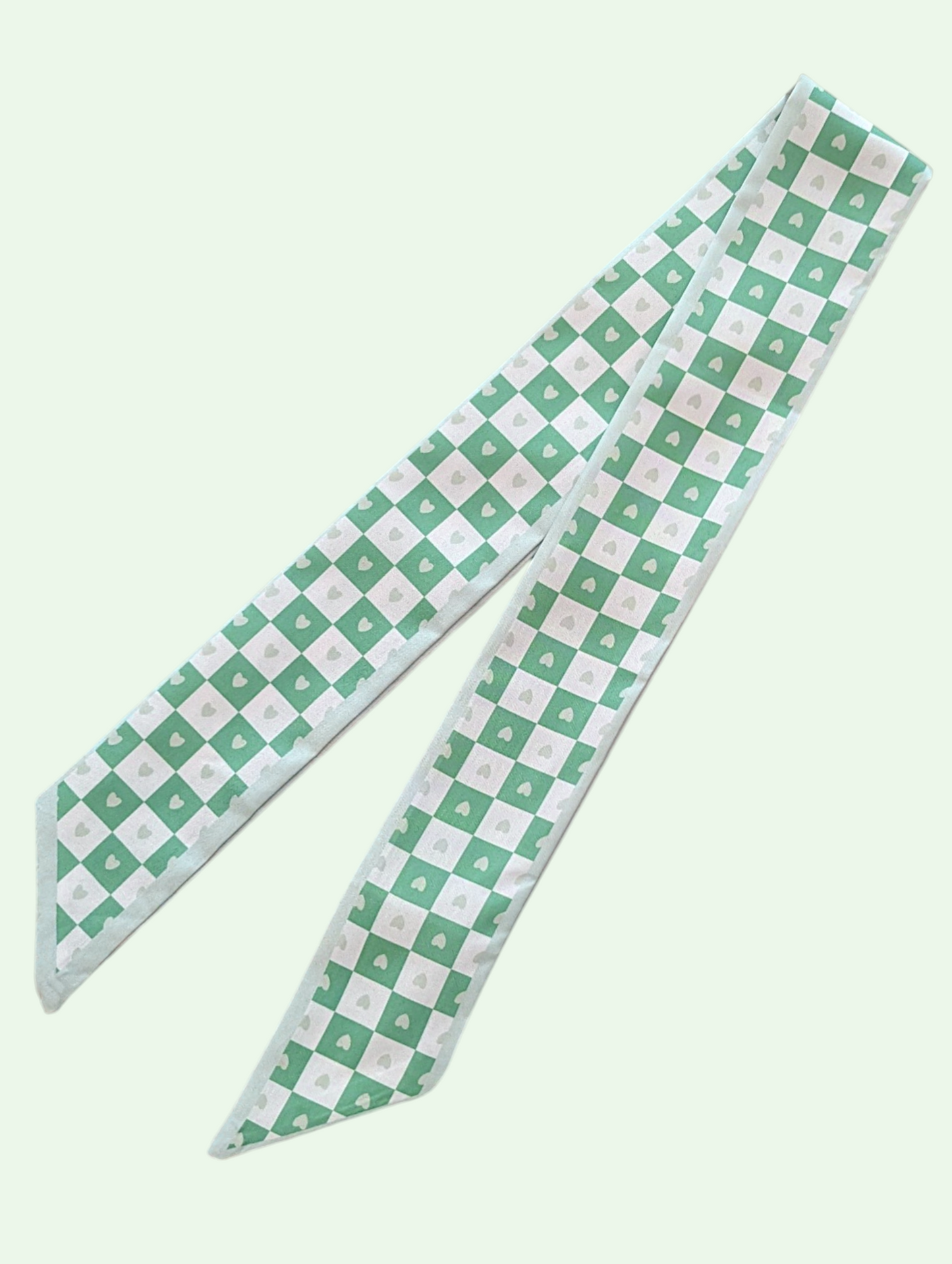  green and white checkered  scarf on a light green background