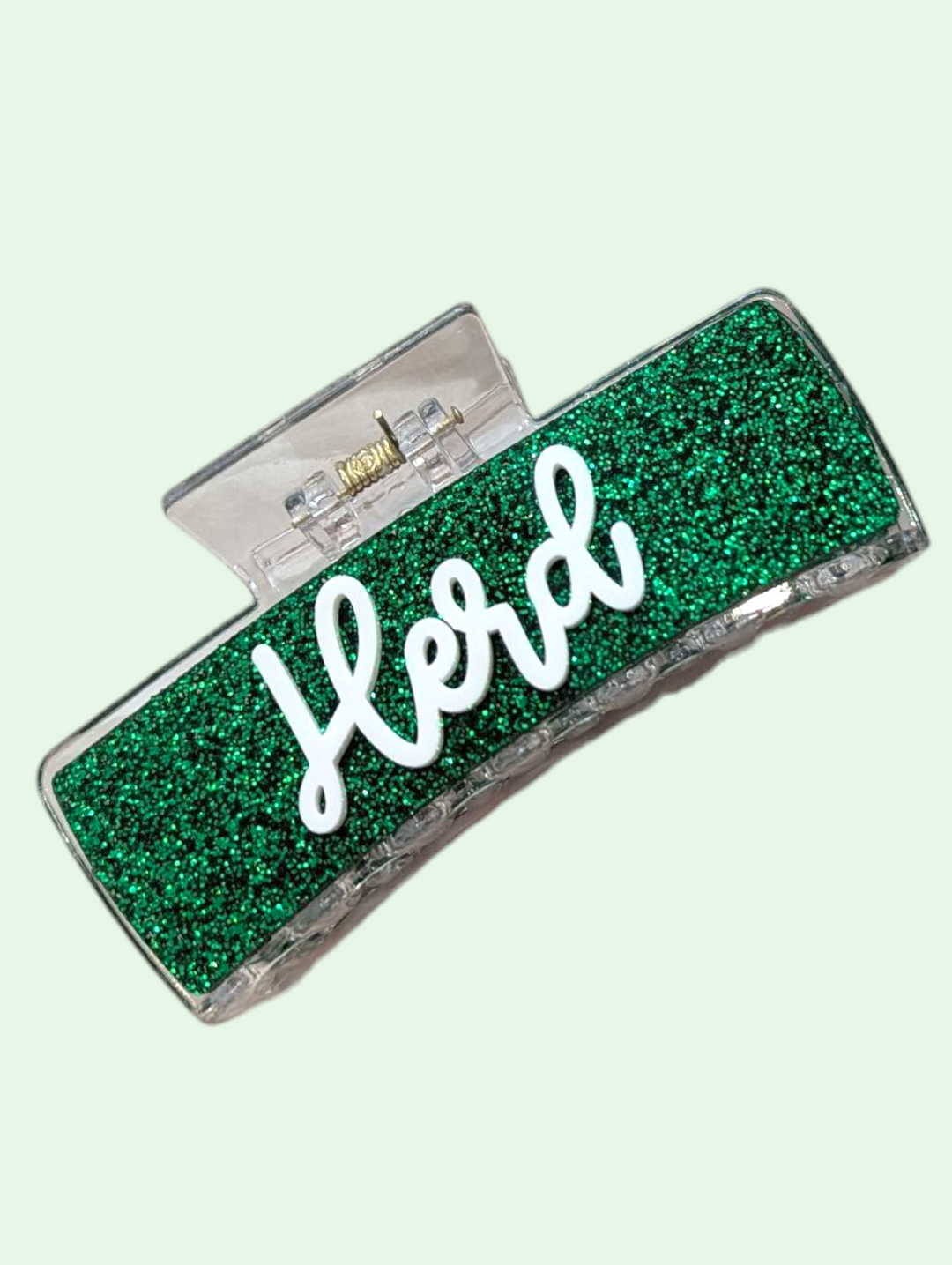 Green glittery case with 'Herd' text on a light green background