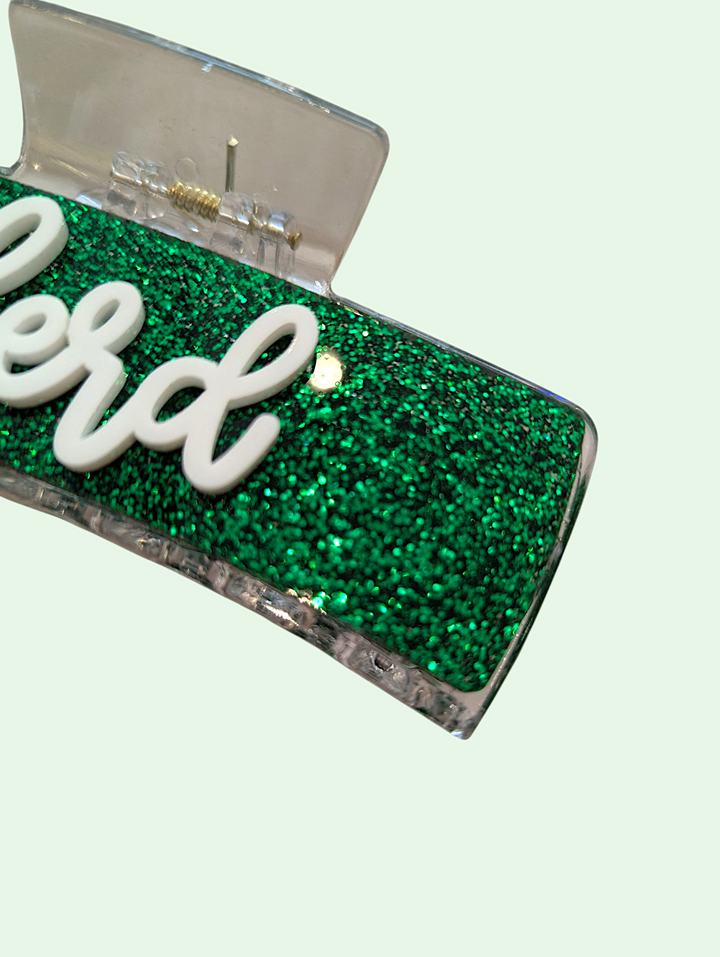Green glittery product with 'herd' branding on a light green background