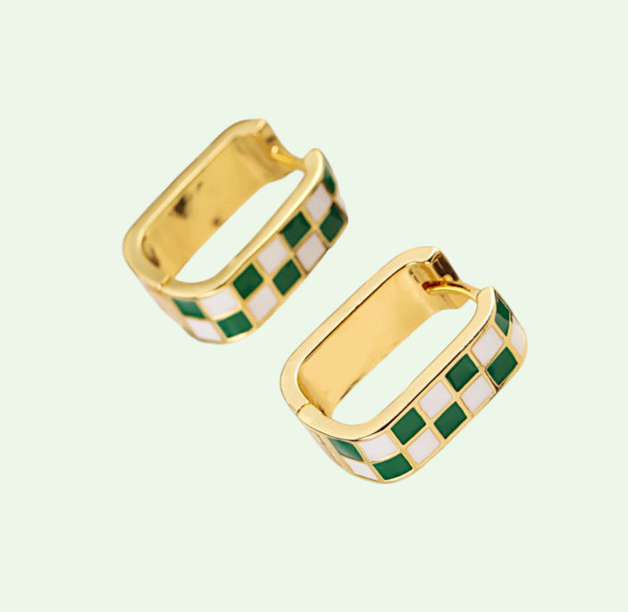 Gold hoop earrings with green and white checkered pattern on a light green background
