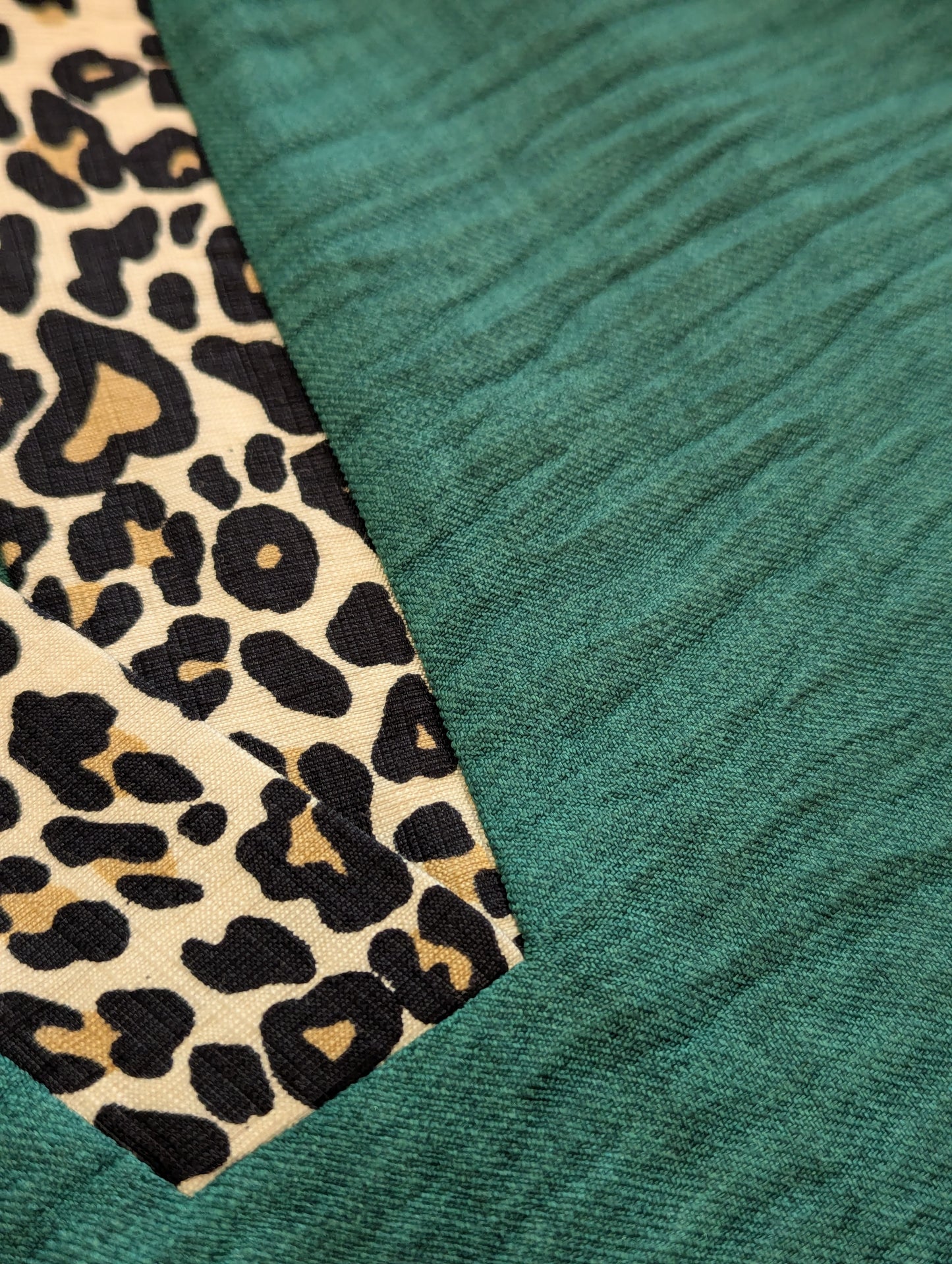 Close-up of green fabric with a leopard print pattern