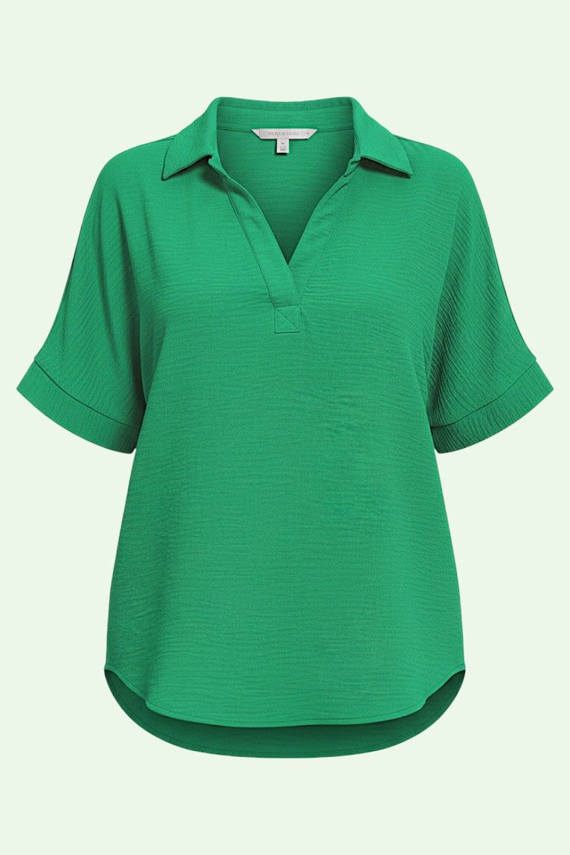Green short-sleeve shirt on a light gray background