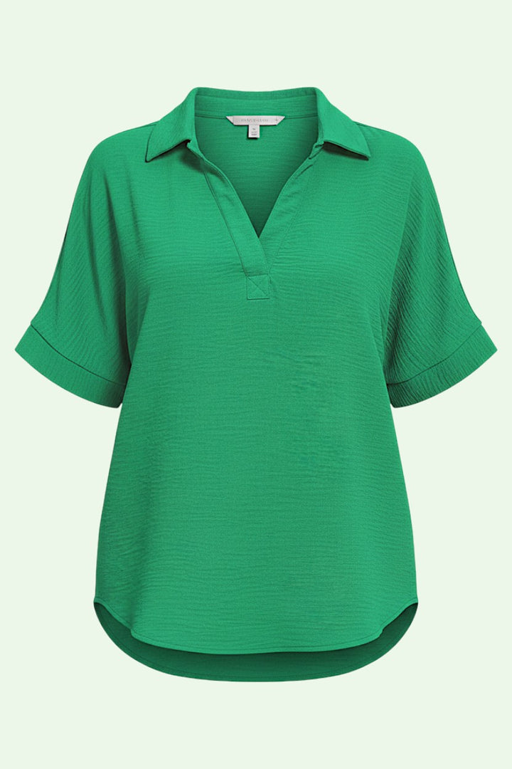 Green short-sleeve shirt on a light gray background