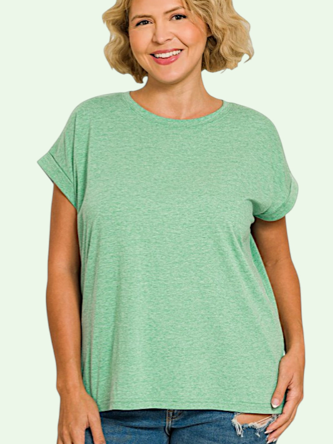 a blonde Woman wearing a green t-shirt against a light background