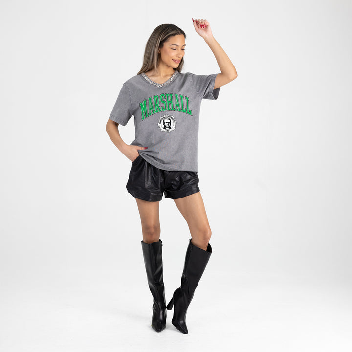 Woman wearing a gray 'Marshall' t-shirt with black leather shorts and tall black boots on a white background