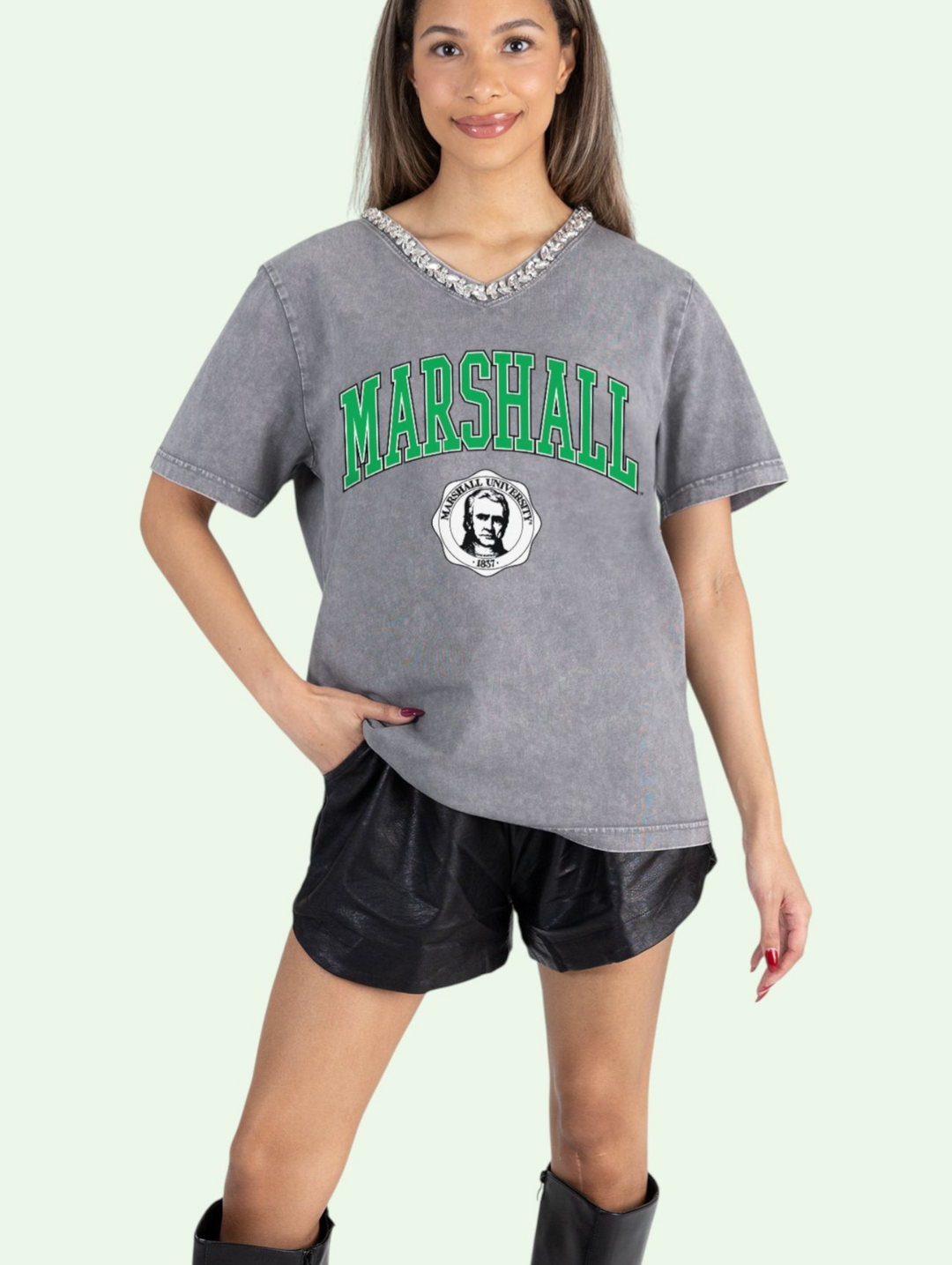 Person wearing a gray 'Marshall' t-shirt with green text on a light green background
