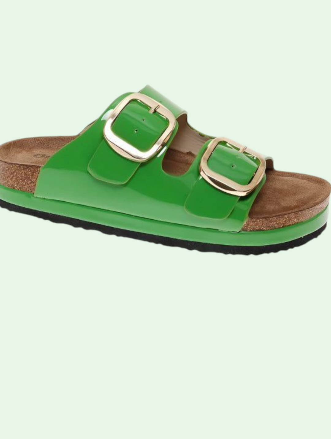 Green sandal with gold buckles on a light green background