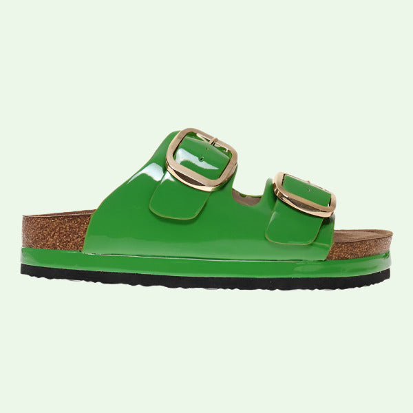Green sandal with gold buckles on a white background