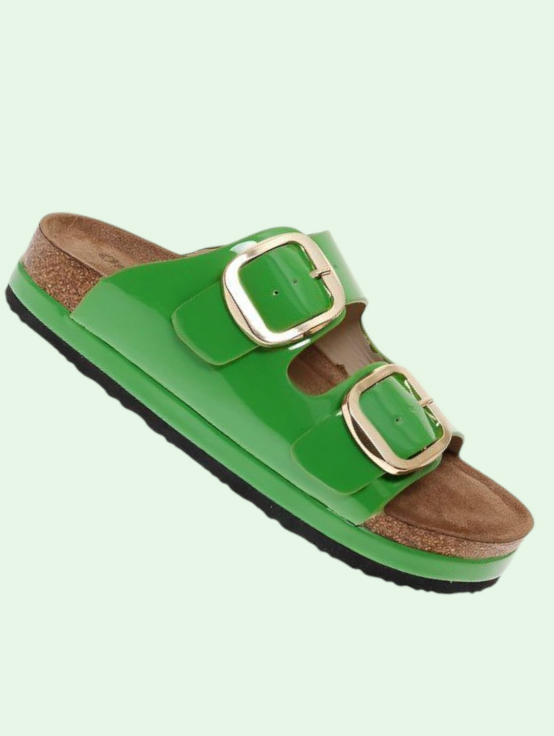 Green sandal with gold buckles on a light green background