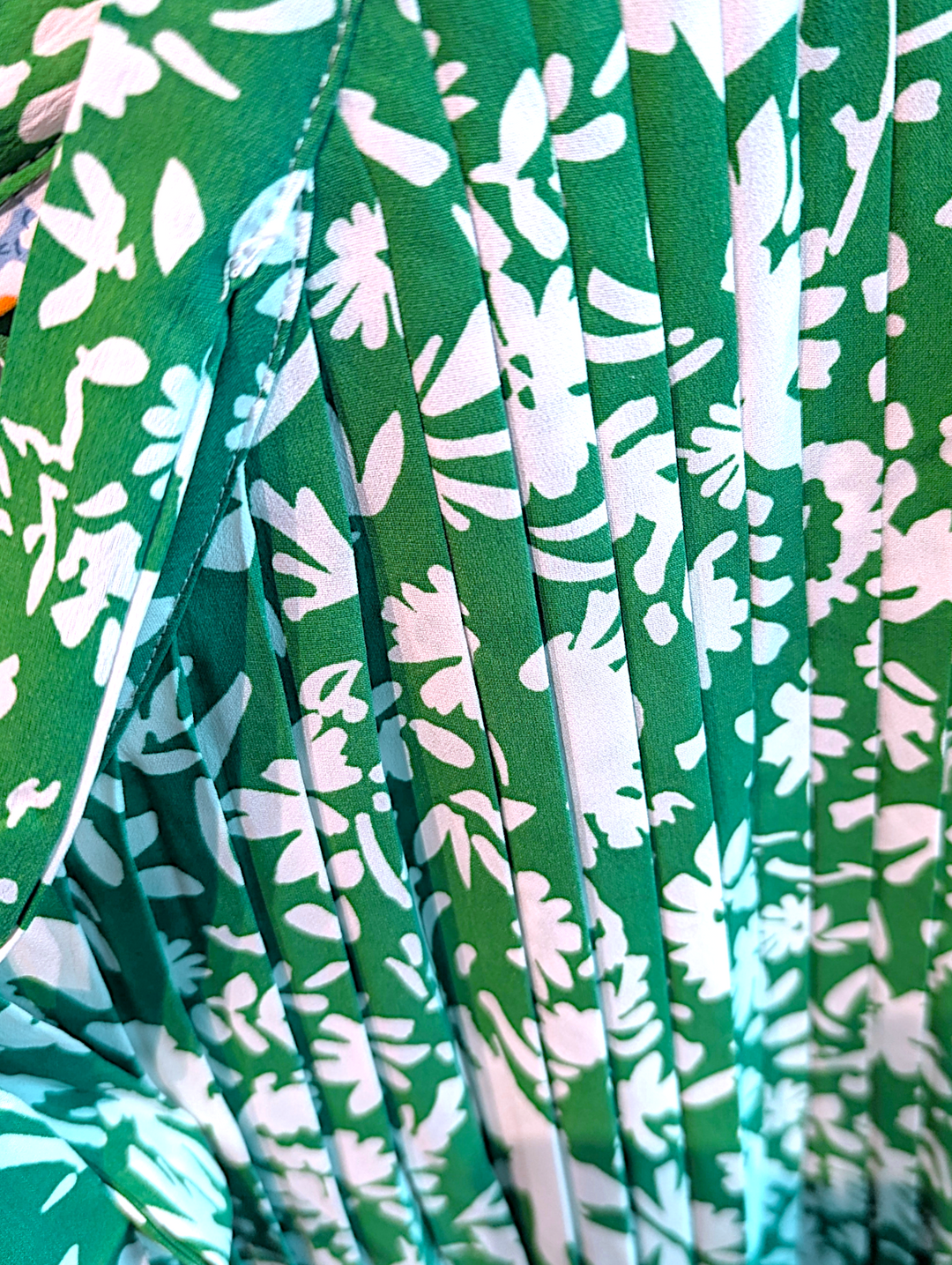 Close-up of green fabric with white floral pattern
