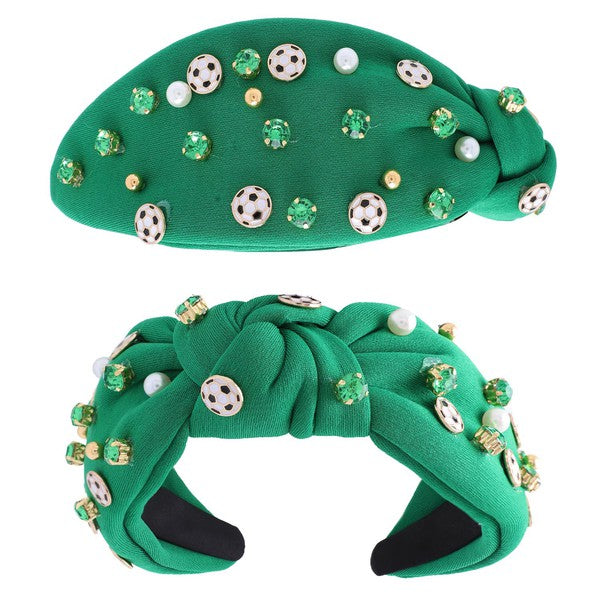 a green knit headband decorated with sewn-on green jewels, wee soccer ball charms and gold beads and silver pearls. 