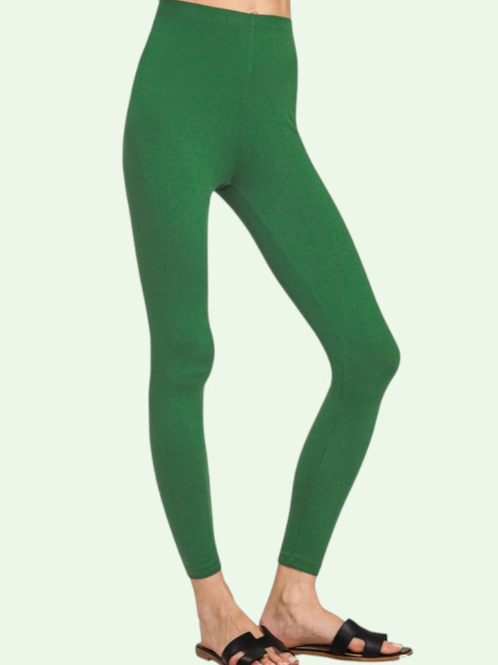Green leggings worn by a person on a light green background