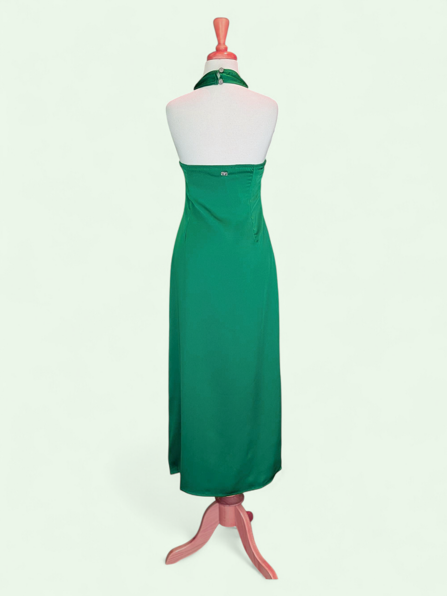 Green dress on a mannequin against a white background