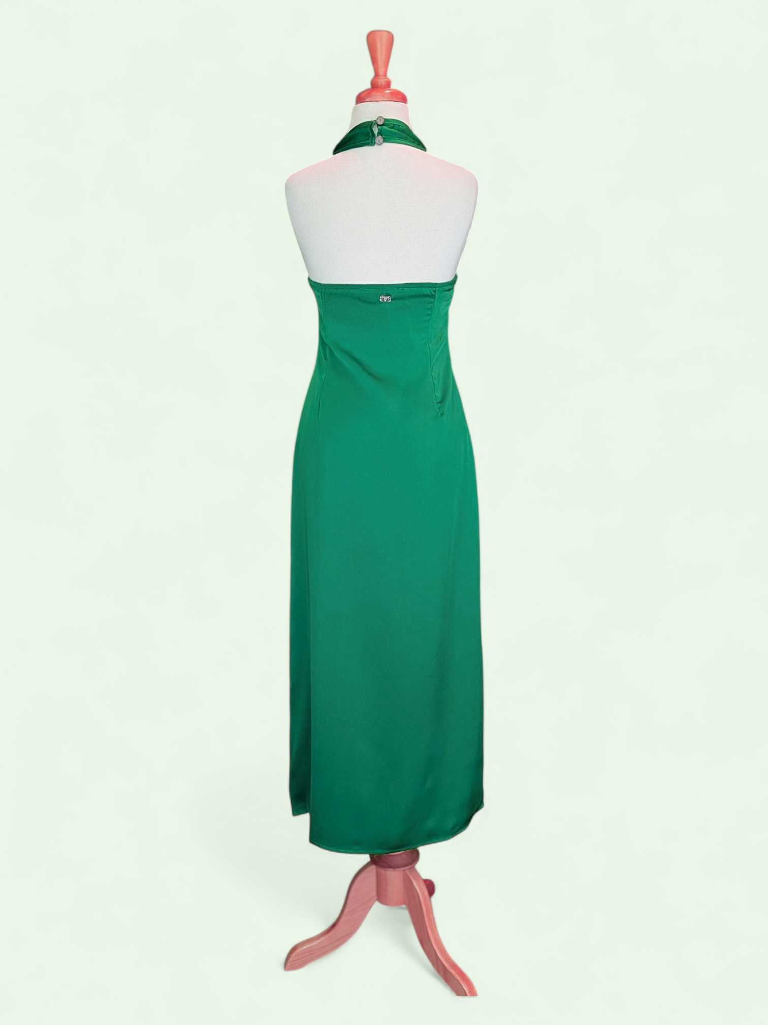 Green dress on a mannequin against a white background