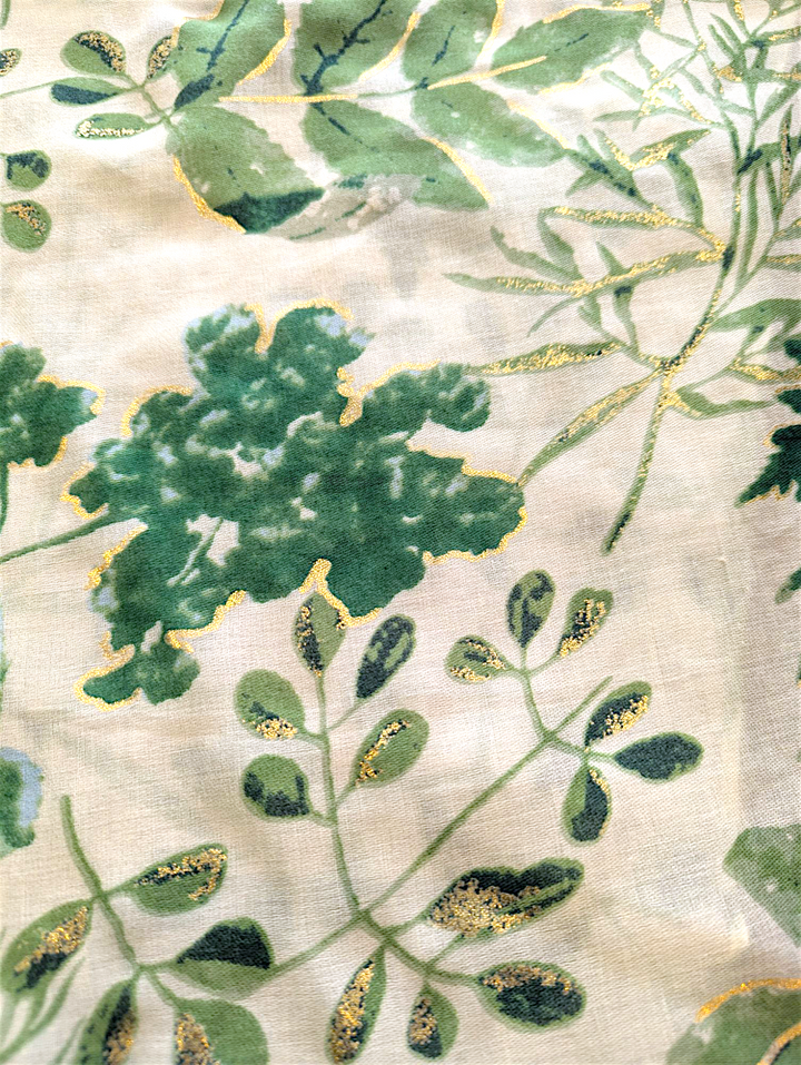 a  detail view of the lena scarf showing the print and the gold accents