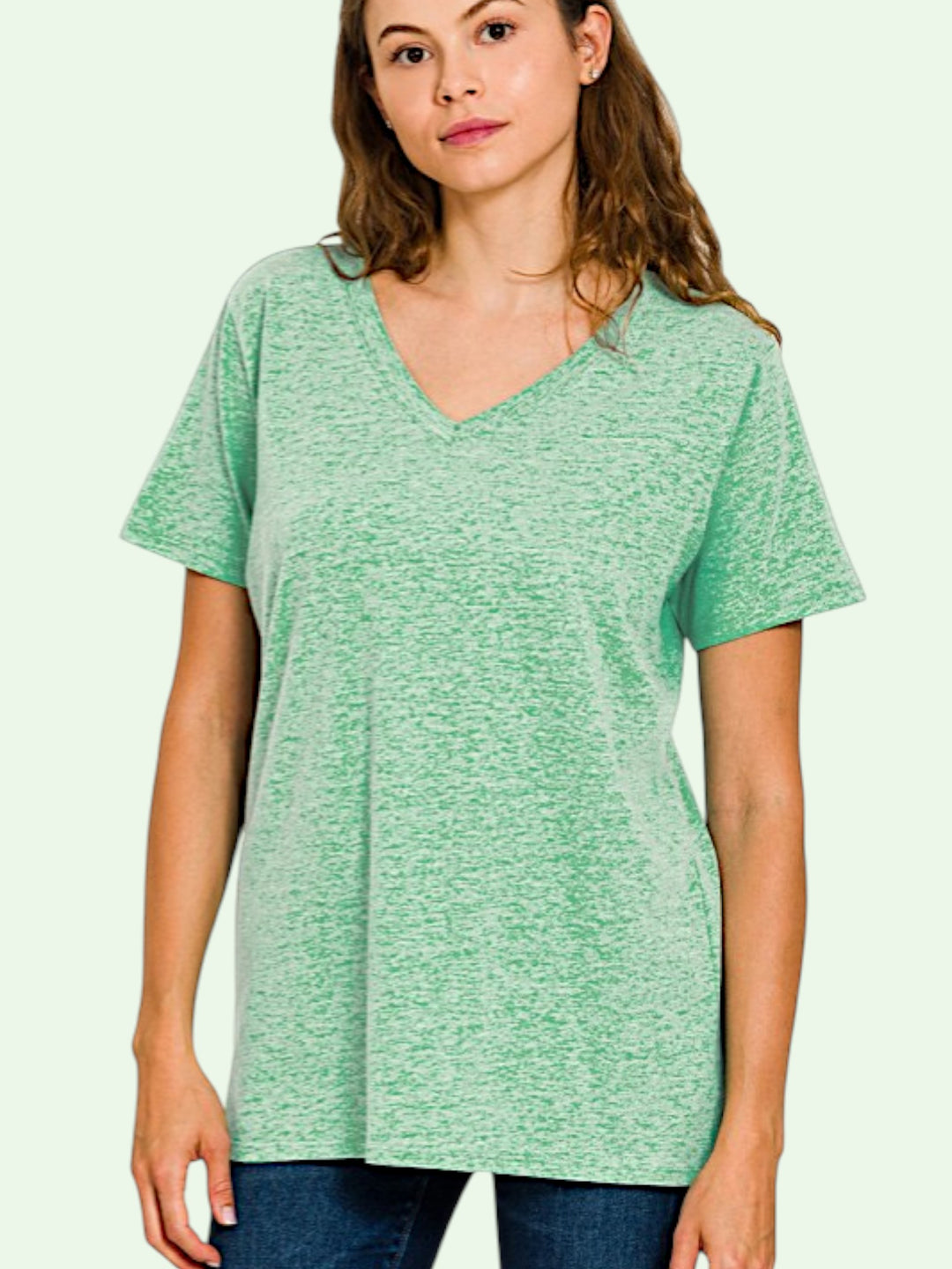 Woman wearing a green t-shirt against a light background