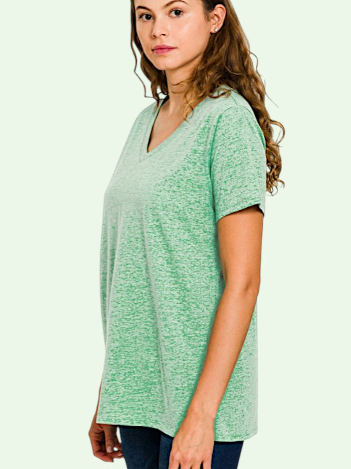 a dark haired model  in the lisa tee on a light background