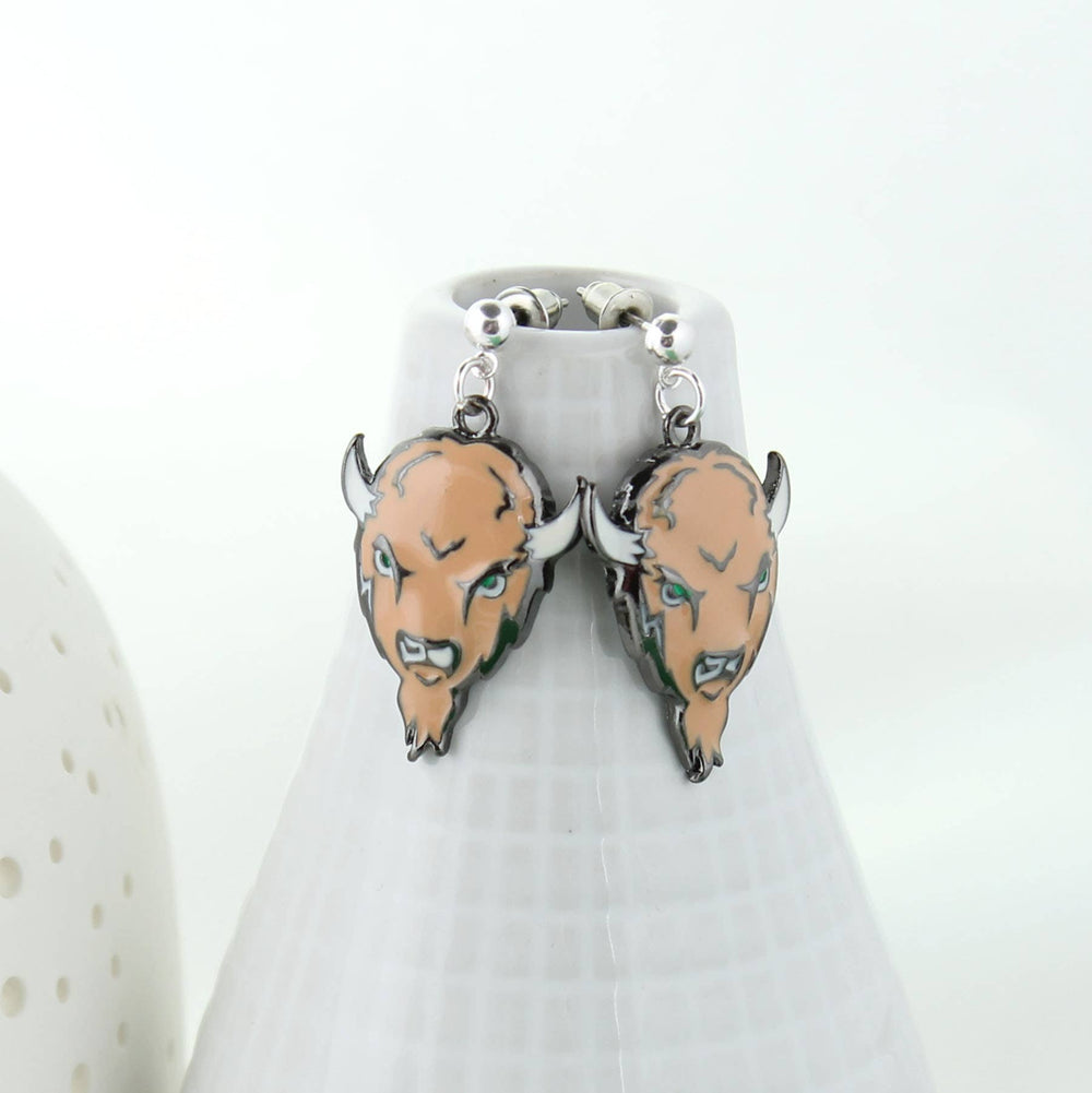 Bison head earrings on a white stand with a white background